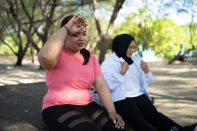 Side view of young woman exercising in park