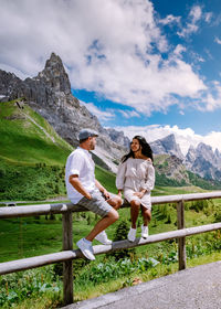 Full length of woman on railing against mountains