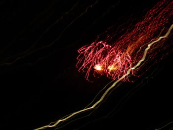 Low angle view of firework display against black background