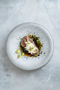 Top view of delightful roasted juicy beef pieces with seasonings serving on plate on table