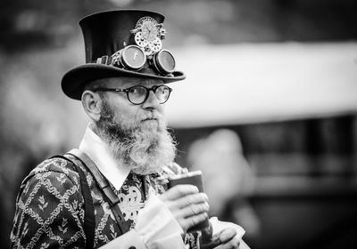 Portrait of man holding bottle outdoors