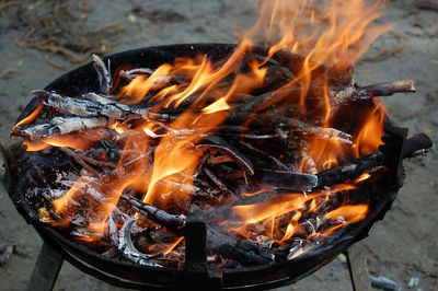 Close-up of fire pit on field at night