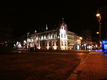 Illuminated city against sky at night