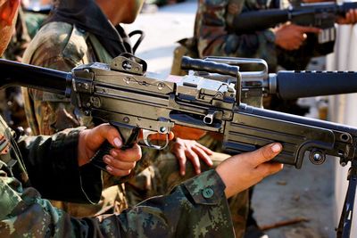 Close-up of soldiers holding guns