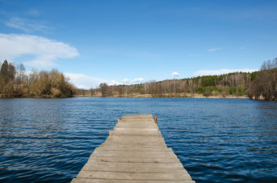 Pier over lake against sky