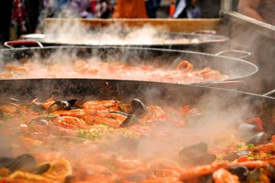 Food cooking in large containers outdoors