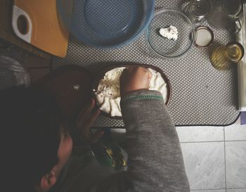 High angle view of boy eating ice cream at table