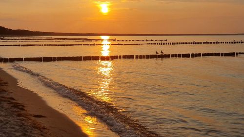 Scenic view of beach against sky during sunset