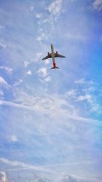 Low angle view of airplane flying in sky