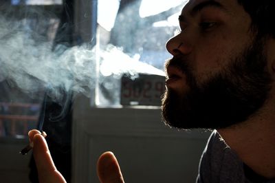 Close-up of man smoking cigarette