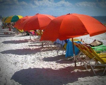 Red umbrella on shore