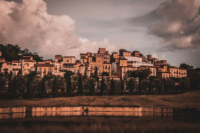 Panoramic view of buildings and trees against sky