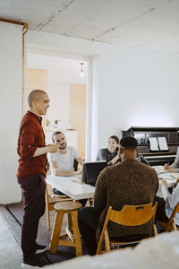 Male hacker presenting business idea during meeting at startup company