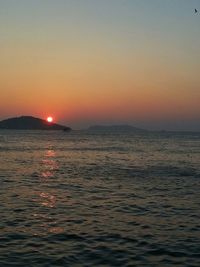 Scenic view of sea against orange sky