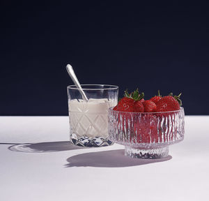 Close-up of drink served on table against black background