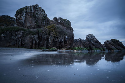 Scenic view of mountain on shore against sky