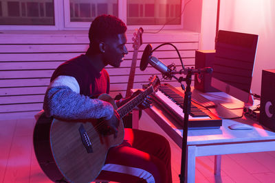 Man playing guitar at music concert