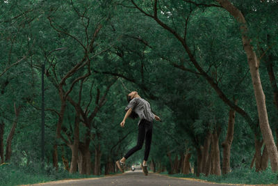 Side view of a woman walking in forest