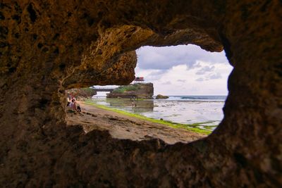 Scenic view of sea seen through cave