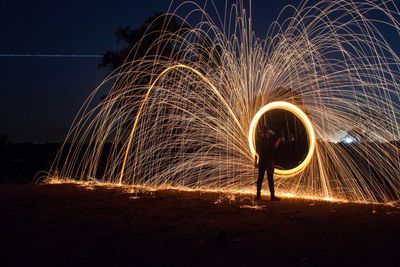 Rear view of man light painting
