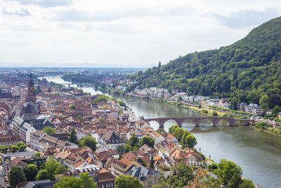 High angle view of river amidst buildings against sky