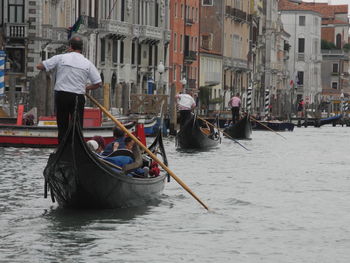 Rear view of gondolier in gondola on grand canal