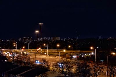 High angle view of illuminated buildings against sky at night