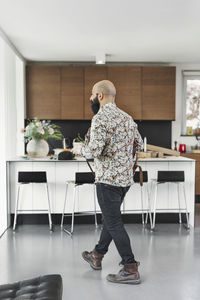 Rear view of man standing on table