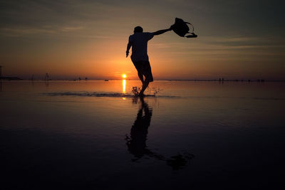 People on beach at sunset