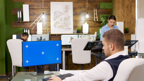 Rear view of woman working in office