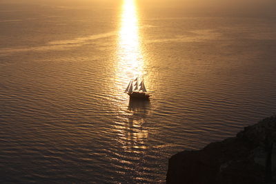 Silhouette boat in sea during sunset