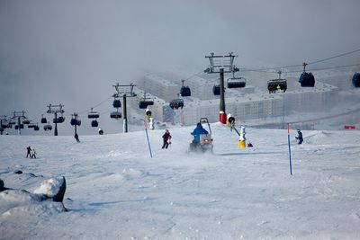 People skiing on snow covered landscape