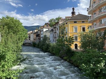 River amidst buildings against sky