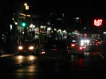 Cars on city street at night