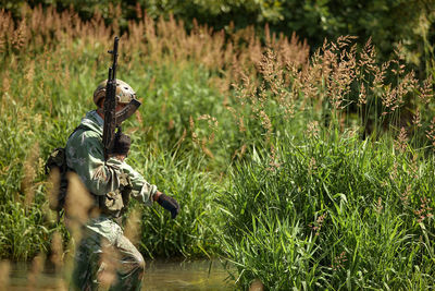 Rear view of woman standing on field