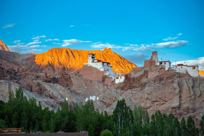 Scenic view of mountains against blue sky