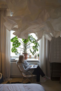 Woman using laptop at home