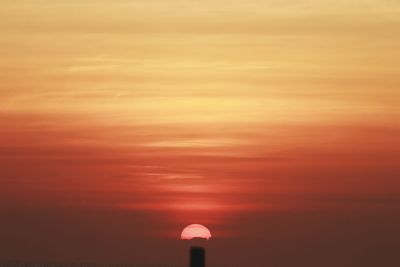 Low angle view of silhouette tower against sky during sunset