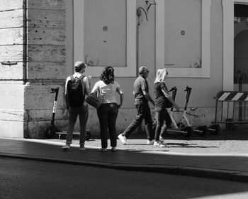 Rear view of people walking on street