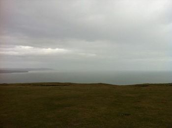 Scenic view of landscape against cloudy sky