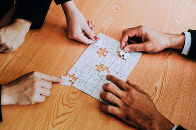 High angle view of man holding hands on table