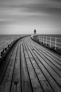 Wooden jetty leading to sea