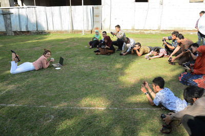 Group of people relaxing on field