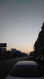 City street against clear sky at dusk