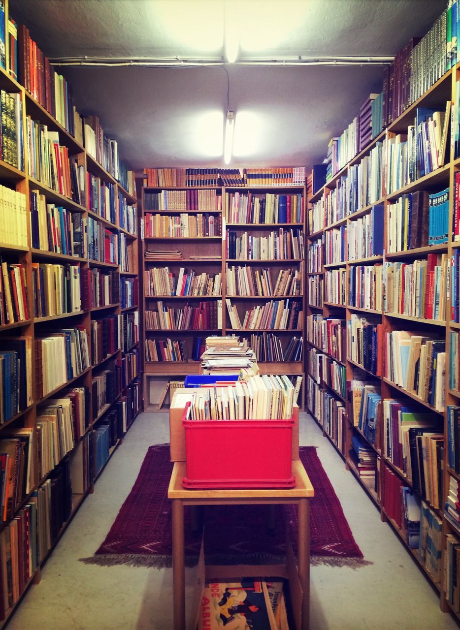 indoors, shelf, arrangement, large group of objects, order, illuminated, in a row, variation, store, bookshelf, retail, choice, table, absence, architecture, no people, empty, library, restaurant, stack