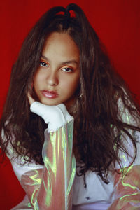 Portrait of teenage girl against brown background
