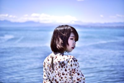 Mid adult woman against sea against sky