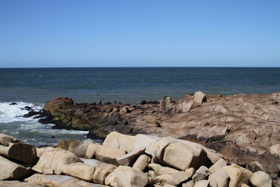 Scenic view of sea against clear blue sky