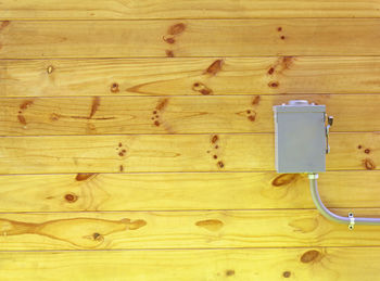 High angle view of mobile phone on wooden floor