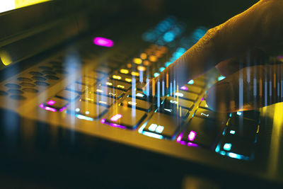 Close-up of hand on illuminated stage